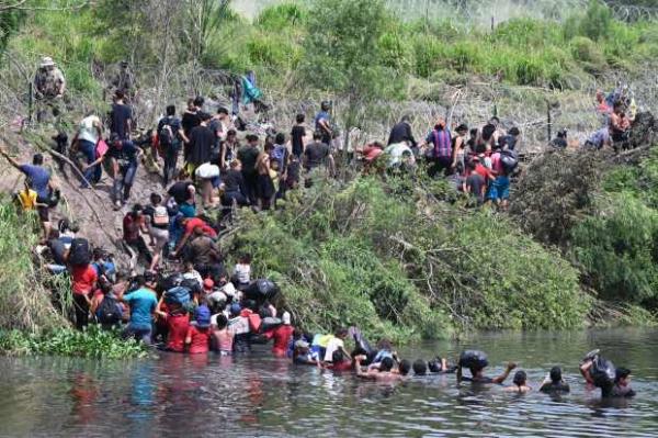 Migrants cross the Rio Grande River as they try to get to the U.S., as seen from Matamoros, Mexico, on May 11, 2023.