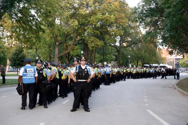 Police officers stand in a line after a March on DNC protest on Monday, Aug. 19, 2024, in Chicago, on standby as they waited for pro-Palestinian protesters to leave Union Park after a two-mile protest march.