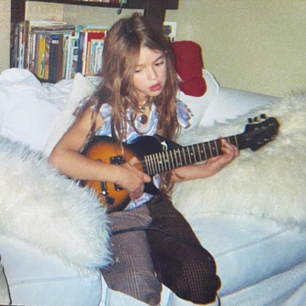 Lucy playing the guitar as a child. 