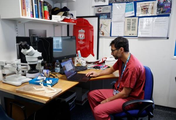 Dr Abdul working on his laptop in the hospital